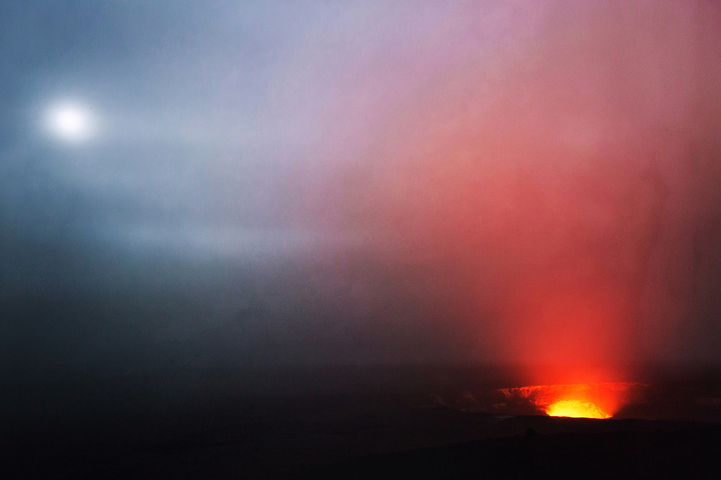 ﻿Crater erupting with moon in the sky